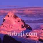 A natural phenomenon involving the illumination of mountain slopes by the sun.